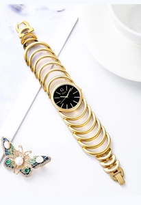Top view of elegant gold link bracelet watch with black dial and butterfly decoration