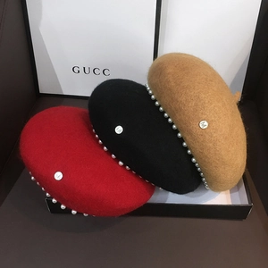 Detailed texture of wool berets with pearl trim and silver M metal buckle in three colors