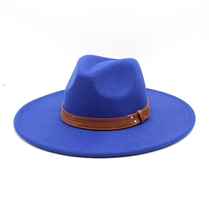 Detail of dark blue fedora hat featuring a brown leather band and silver metal rivets