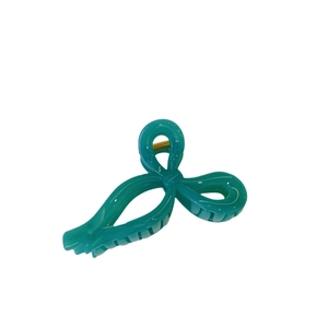 Minimalist turquoise ribbon bow hair claw clip with glossy finish and metal spring mechanism