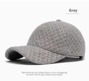 Detail of gray knitted baseball cap featuring a distinctive diamond pattern texture