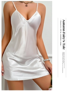 Detailed view of white satin strap dress featuring a deep V-neck and silky texture