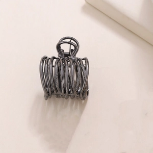 Detailed view of a dark grey hollow metal hair claw clip for high ponytail styling