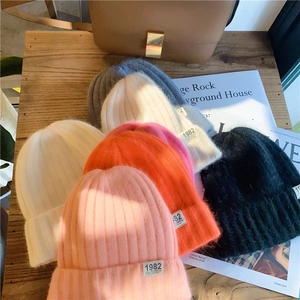 Detail showing various colors of knitted beanies with vintage 1982 California labels