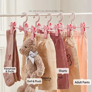 Pink adjustable kids clothes hanger with bow detail and clips for pants and socks
