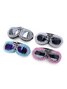 Detail of gothic punk goggles featuring metal chains and skull charms in four colors