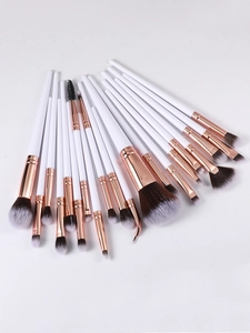 Detailed overhead view of 20 professional makeup brushes with rose gold ferrules