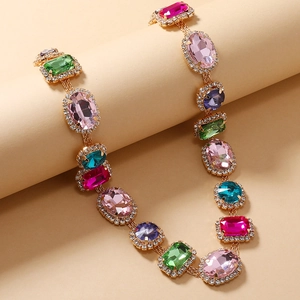 Detailed shot of vintage gold necklace with multi-colored crystals and diamond accents