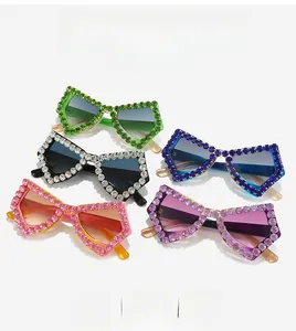 Macro view of butterfly sunglasses with hand-set rhinestones and gradient lenses