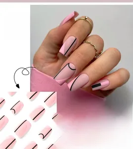 Detail view of pink and nude matte press-on nails with black geometric lines and semi-circles