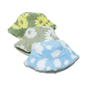 Detailed view of plush teddy fleece bucket hats with 3D floral daisy patterns