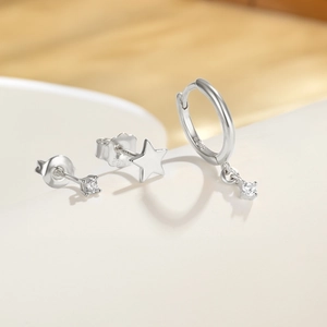 Macro shot of 925 sterling silver earring set with sparkling cubic zirconia and star stud