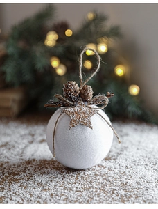 Detailed view of white foam Christmas ball with pine cone and wooden star decorations