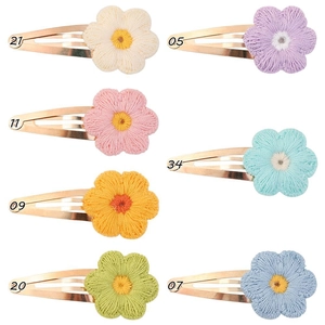Detail of colorful knitted sunflower hair clips for kids in 7 macaron candy colors