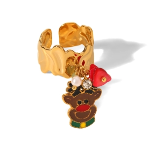 Detailed macro view of a wavy gold stainless steel ring featuring a brown reindeer charm