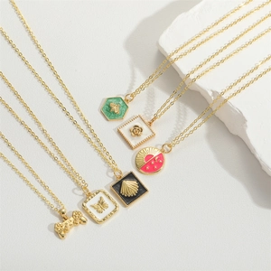 Set of six gold enamel pendant necklaces featuring bee, rose, and retro gamepad designs