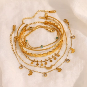 Gold plated stainless steel bracelet set with moon, butterfly pendants and zircon stones