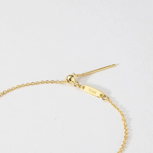 Macro view of adjustable S925 sterling silver chain with slider bead and engraved tag