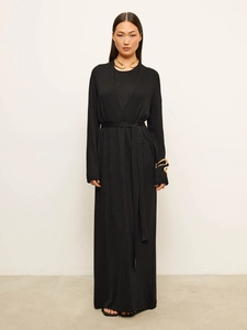 Detail of soft black knitted long-sleeve cardigan with waist belt and gold jewelry
