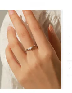 Detail of V-shaped S925 sterling silver ring with three sparkling round moissanite stones