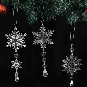 Three-piece set of crystal snowflake Christmas ornaments with beads on a dark background
