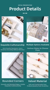 Detailed close-up of beige velvet jewelry organizer tray with rings and necklace slots