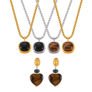 British retro jewelry set with tiger eye square pendants and heart earrings on white background