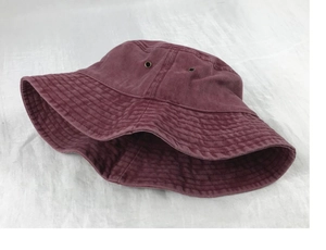 Detailed close-up of wine red cotton bucket hat with breathable metal eyelets
