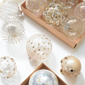 Champagne champagne mesh Christmas ornaments with gold glitter dots in a rustic gift box