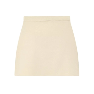 Detail shot of a beige high-waisted knitted mini skirt with textured fabric and clean edges