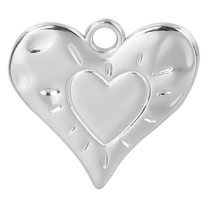 Detailed macro view of heart-shaped stainless steel pendant with radial groove texture