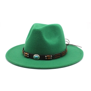 Detail of green wool felt hat featuring brown braided leather band and turquoise stone