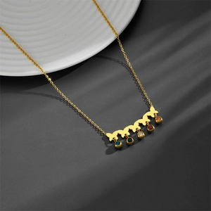 Detail view of titanium necklace with gold butterfly pendants and multi-colored zircons