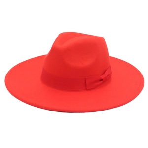 Detail showing red wide-brim wool fedora hat with satin ribbon bow on white background