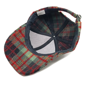 Detail view of plaid baseball cap interior with reinforcement tape and polyester lining