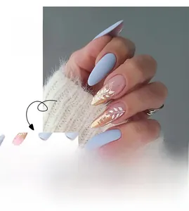 Detail of blue matte press-on nails featuring white leaf patterns and gold foil accents