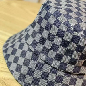 Close-up of blue and grey checkerboard pattern on denim fabric of the bucket hat