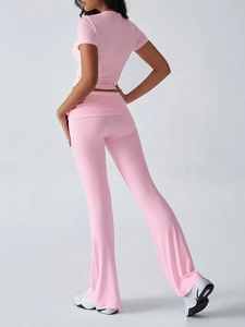 Rear view of pink slim fit short sleeve T-shirt and matching trousers set for women