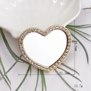 Detail view of heart-shaped rhinestone mirror with dimensions 51.5mm width and 44.6mm height