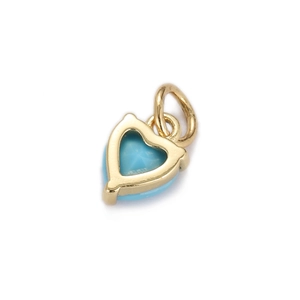 Close-up of gold-plated heart pendant featuring turquoise-style blue zircon inlay