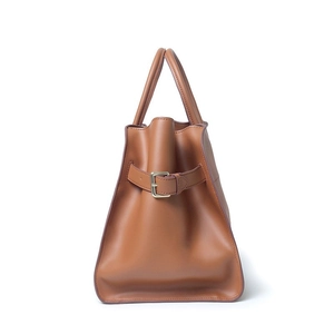 Brown vintage leather tote bag with side belt buckle detail and dual top handles