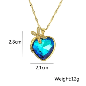 Detailed view of blue heart crystal pendant with gold dragonfly and dimension markers