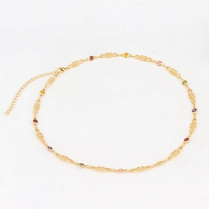Detail view of gold-plated necklace featuring colorful crystals and adjustable lobster clasp
