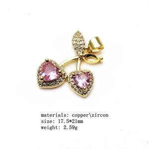 Detail view of cherry pendant charm in copper with pink zircon heart-shaped stone