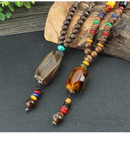Close-up of vintage ethnic beaded necklaces with wooden pendants and natural textures