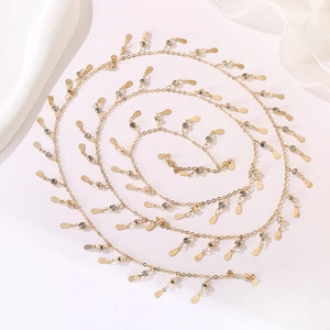 Detailed view of golden link chain with sparkling rhinestones and teardrop sequins