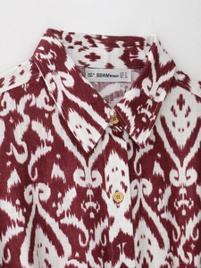 Detail of red ikat print shirt collar showing high-quality cotton linen texture and buttons