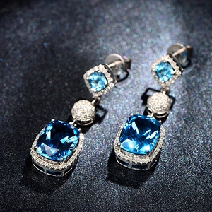 Luxurious silver drop earrings featuring cushion-cut blue gemstones and zircon stones