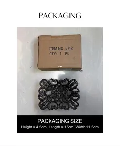 Detailed view of vintage cast iron soap dish with floral patterns in original packaging