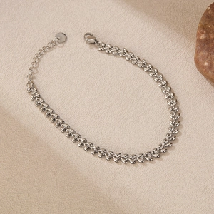 Close-up of silver wheat link bracelet with lobster clasp and adjustable extension chain